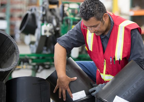 A Ferguson Industrial HDPE pipe fusion expert working with HDPE in an industrial workshop