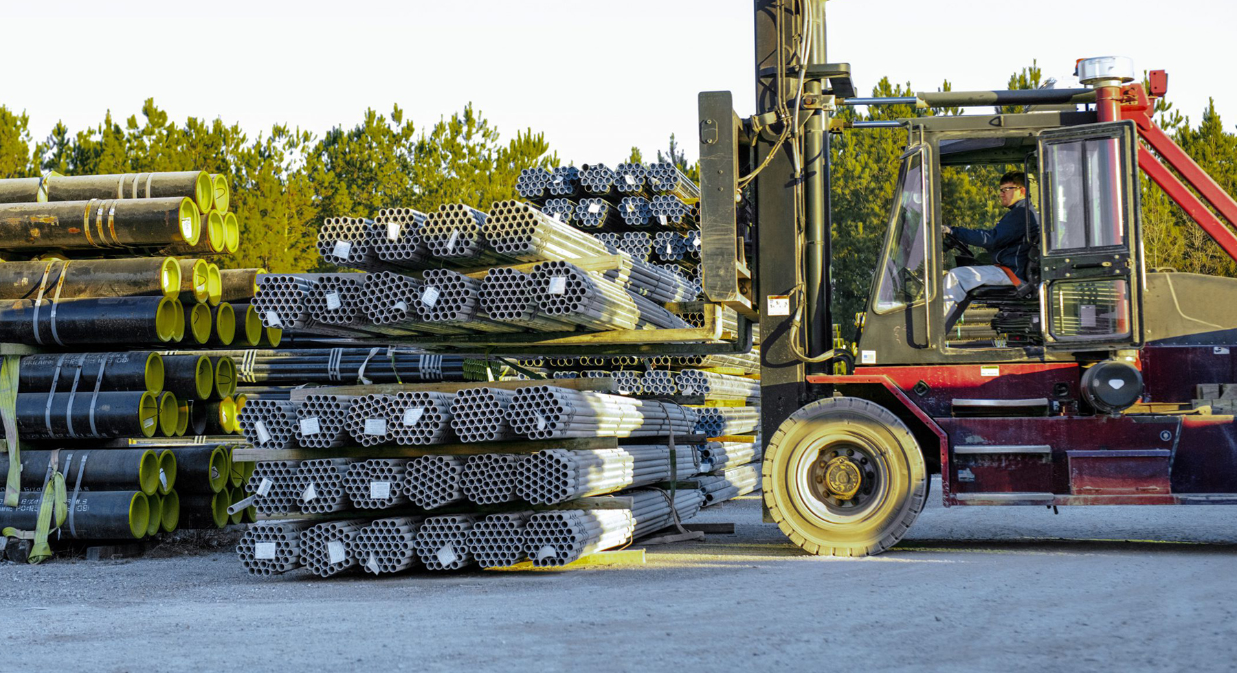 Ferguson Indsutrial unloading a large supply of pipes to a customer in need of industrial turnaround support.