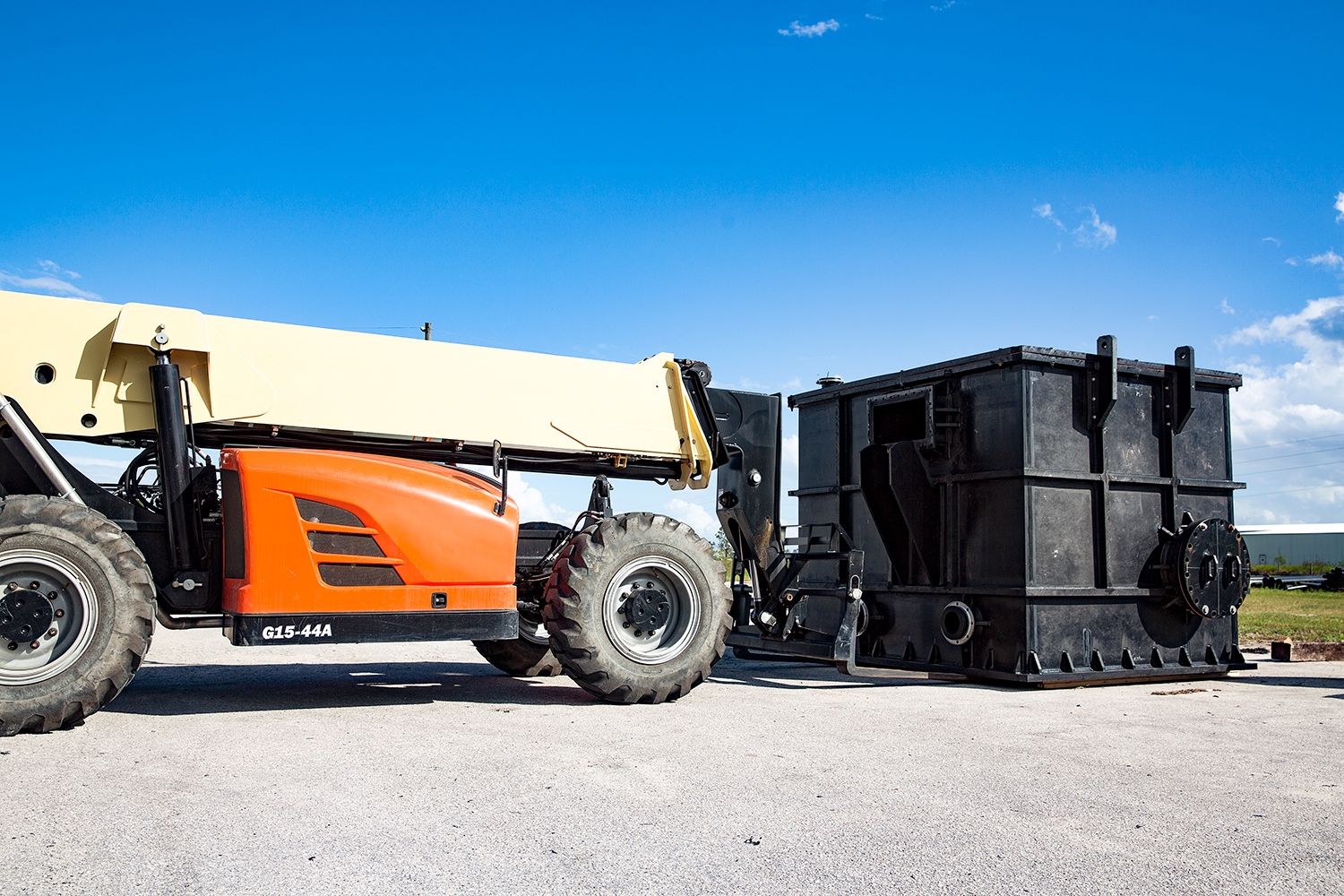 A construction vehicle delivering manholes or vaults to a job site.