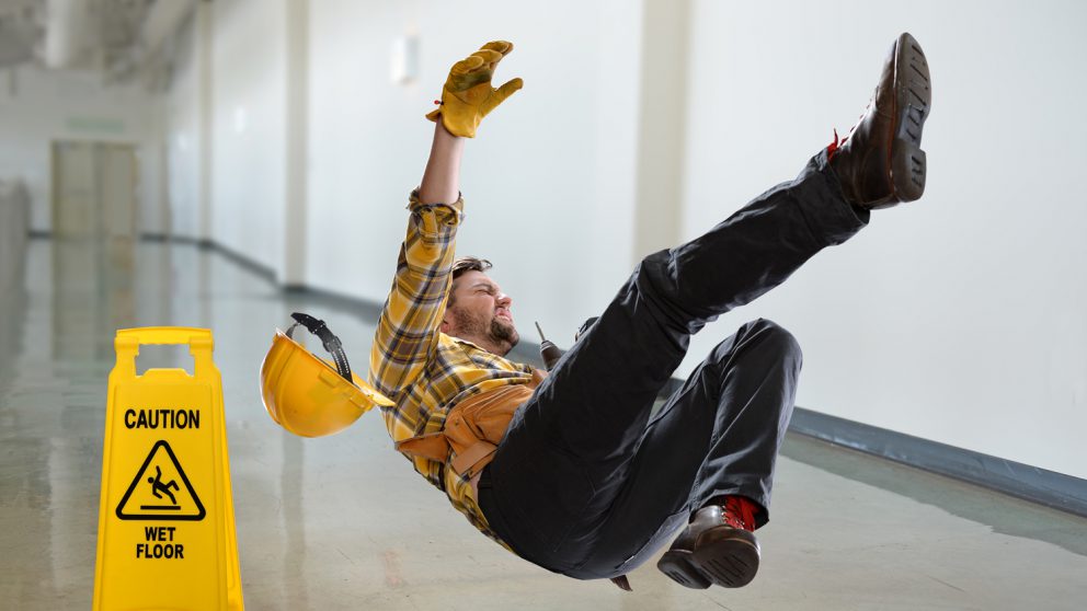 A man slipping in a work environment due to improper safety implementation.