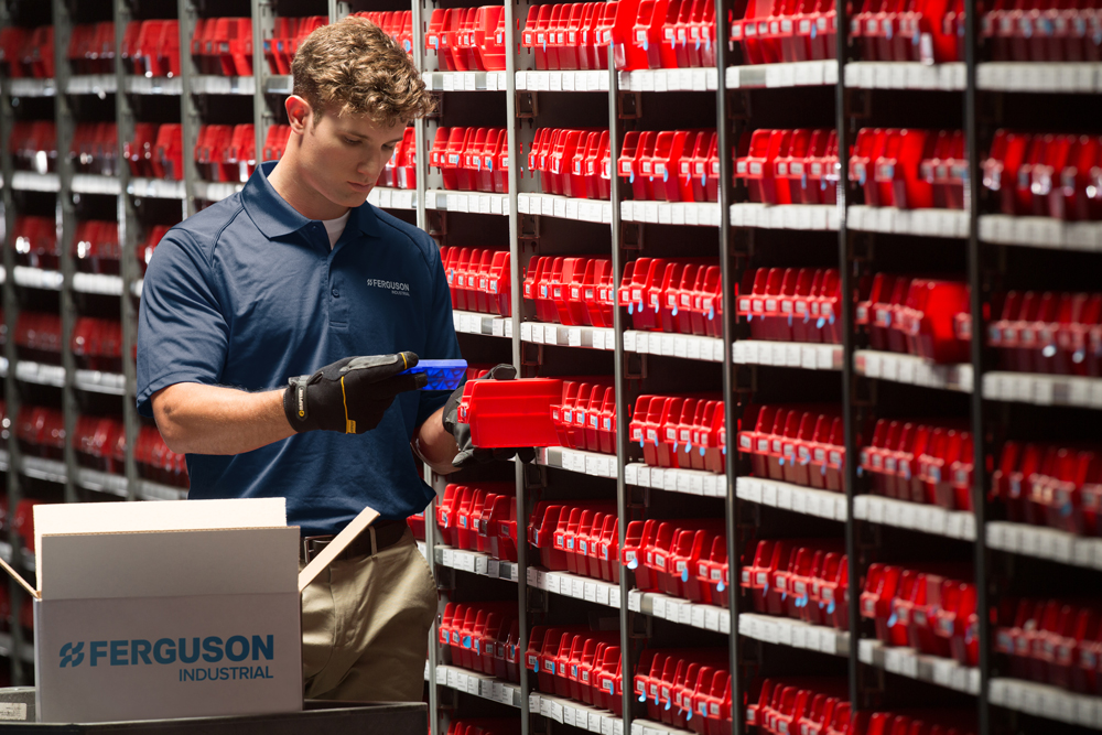 Image of male in stock room reviewing a product - contact us for questions.