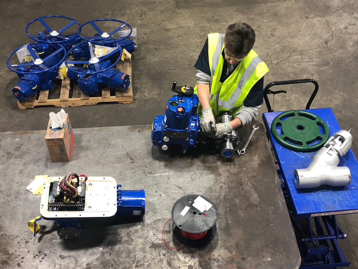 A Ferguson Industrial expert technician working on a Limitorque L120 actuator at our Blue Ribbon Service Center