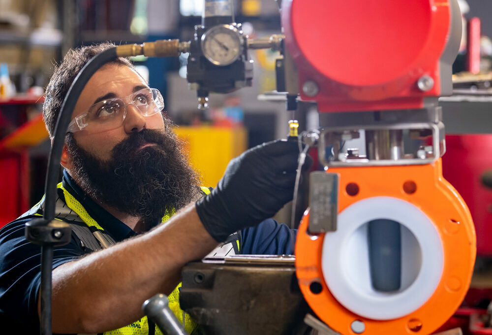 A technical expert pressure testing an industrial flow control valve.