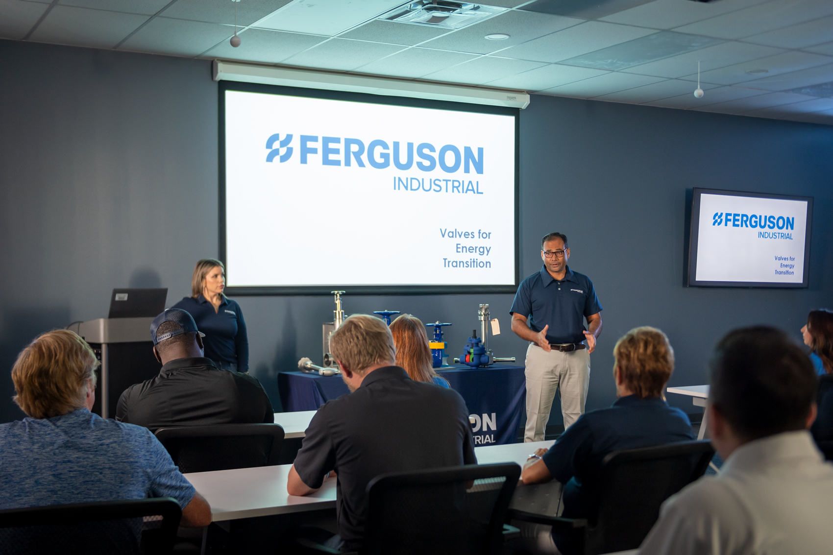 Ferguson Industrial experts presenting a training powerpoint to a room of flow control personnel.