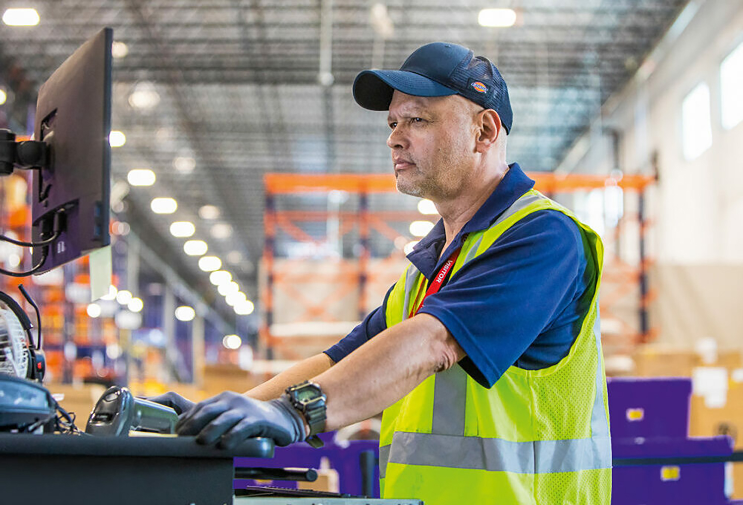 An associate using a point of use station for inventory management.