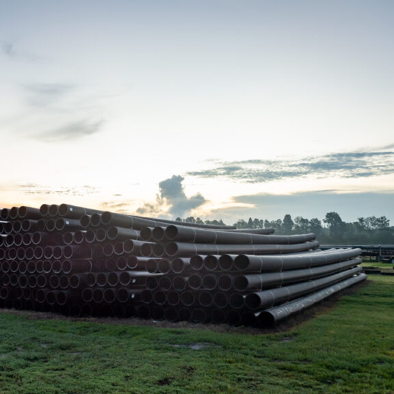 A large HDPE pipe delivery to an industrial site.