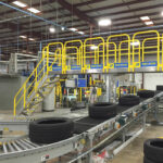 Erectastep stairs and platform that extend over an assembly line in a tire factory