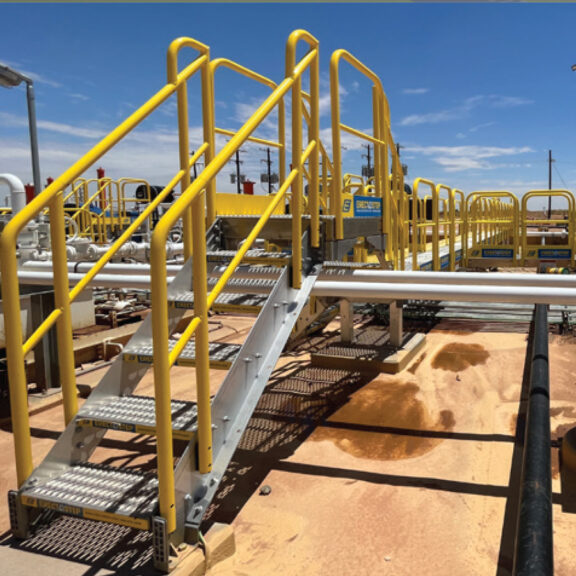 ErectaStep modular access stairs and crossovers installed at an oil plant.